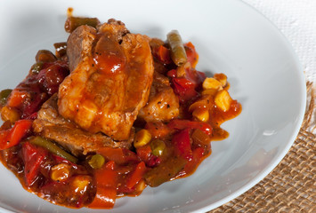 Pork ribs with corn, pepper, tomatoes and green beans.
