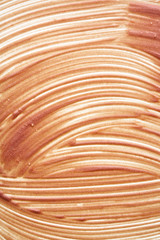 Gently beige strokes and texture of face highlighter or acrylic paint isolated on white background