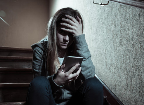 Beautiful lonely young girl depressed and worried suffering from bullying and harassment at school