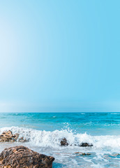 Soft wave crashing stone at bay. Stones by the sea. Sea wave breaks on beach rocks landscape. Sea...