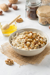 Oatmeal with nuts (hazelnuts, walnuts) and honey, porridge for Breakfast. Tasty, healthy food