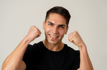 Close up portrait of surprised and happy young man celebrating winning lottery, victory or success