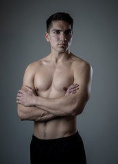 Portrait of strong healthy handsome Athletic man isolated on neutral background