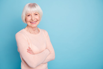 Portrait of cheerful woman looking at camera with her beaming smile isolated over blue background