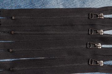 Pack a lot of black metal brass zippers stripes with sliders pattern for handmade sewing tailoring...