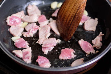 Stir fried pork with garlic in a hot pan, Asian food cooking