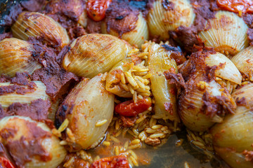 Stuffed onions with rice and tomato sauce