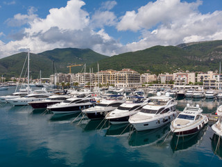 Fototapeta na wymiar Aerial view of Porto Montenegro. Yachts in the sea port of Tivat city. Kotor bay, Adriatic sea. Famous travel destination.