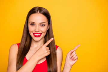 Photo of amazing lady bright lipstick nice indicating fingers empty space advising cool offer wear sun hat red swimming suit isolated yellow background