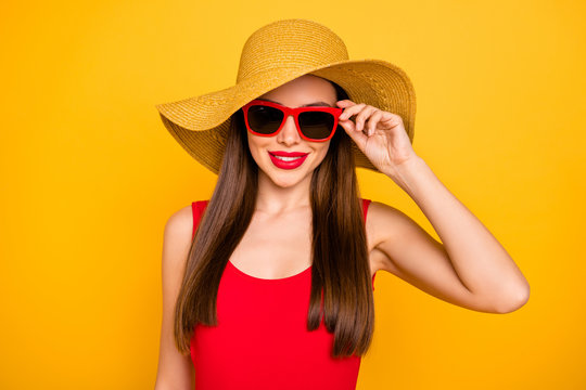Close up photo of cheerful amazing lady bright lipstick nice colorful look trip voyage wear specs sun hat red swimming suit isolated yellow background