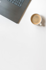 Minimal still life black laptop and a white cup of coffee a wide banner with copy space, business and freelance work top view composition
