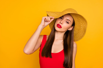 Close-up portrait of her she nice attractive glamorous lovely lovable charming cute gorgeous winsome straight-haired lady touching hat isolated on bright vivid shine yellow background