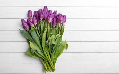 Bouquet of tulips on white background of the wooden planks.