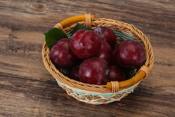 Plum heap in the wooden basket