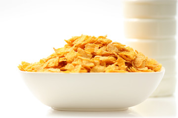 cornflakes in a bowl on white background
