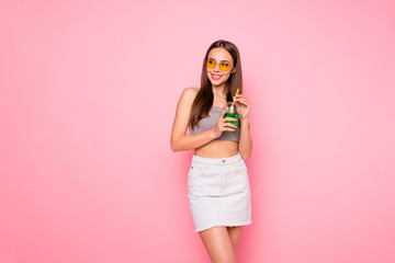 Portrait of lovely lady looking holding plastic cup wearing yellow eyewear eyeglasses isolated over pink background