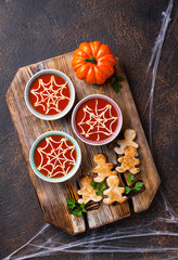 Tomato soup and bread in shape of men.