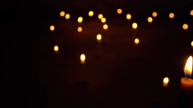 Dolly shot of Candle light in the dark