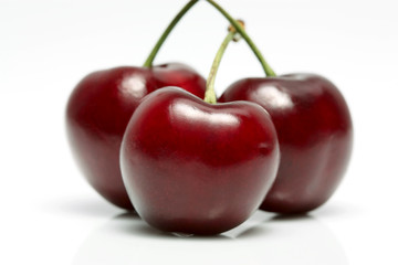 three cherries on white background