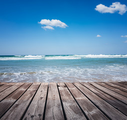 Fototapeta na wymiar Wooden walkway on the tropical beach at sunny day