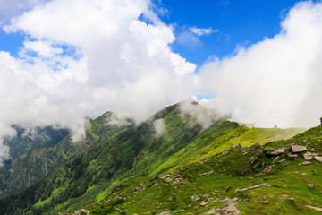 Fototapeta na wymiar Man walks in clouds at 12000 ft from the sea level(right) at Chanderkhani Pass, India