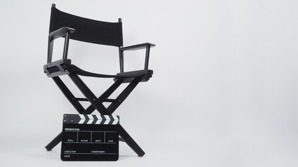 Black Clapper board or movie slate with director chair use in video production or movie and cinema industry. It's put on white background.