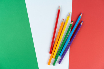 Lgbt colored pencils lie on flag Italy from texture colored cardboard. concept life of Italian lgbt community.