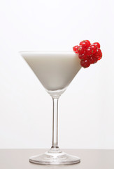 White cocktail decorated by red currents