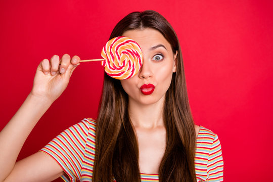 Close-up photo portrait of nice cool optimistic lady fooling around grimacing holding candy near face isolated bright background