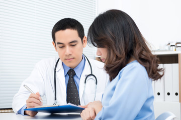 Young woman patient consulting with Asian male doctor