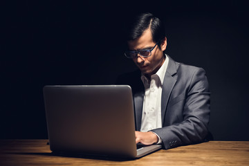 Busy businessman working in office late at night