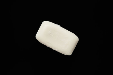 top view of white soap isolated on black with copy space
