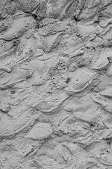 Rough cement plaster on the wall. Facade plaster background. Single-ply monolithic plaster decorative background. Single layer scraped cement plaster wallpaper. Exterior building structure backdrop.