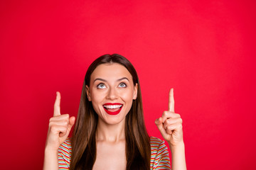 Photo of pretty lady index fingers indicating up empty space wear casual outfit isolated burgundy background