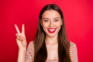 Closeup photo of pretty lady holding hand in v-sign symbol wear casual outfit isolated burgundy background