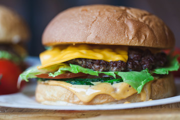 Close up delicious fresh homemade burger on a wooden table