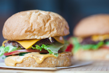 Close up delicious fresh homemade burger on a wooden table