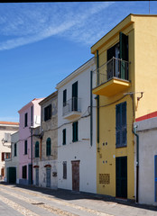 Fototapeta na wymiar Row of colourful houses along the promenade in Alghero in Sardinia