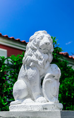 White lion guard, entrance gate sculpture, old Greek house statue decoration. Historical place excursion concept.