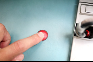 Red button under the index finger