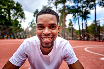 Young black basketball player smiling at the camera