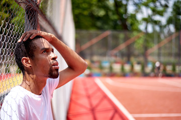 Black basketball player posing in the field outdoors