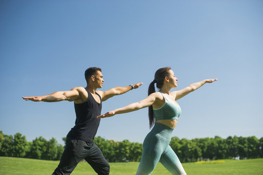 Man and woman practicing yoga outdoor