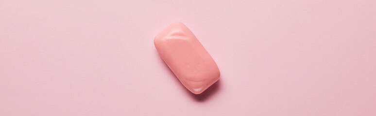 panoramic shot of bright soap on pink background with copy space