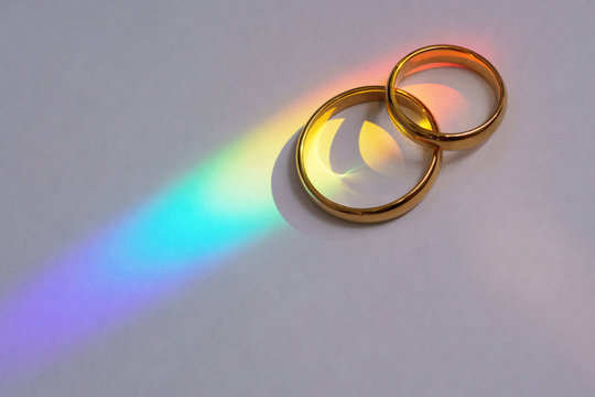 Two wedding rings with rainbow.