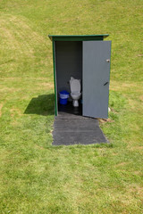 Toilet on a green meadow