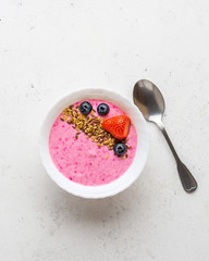 Smoothie bowl with fresh berries, golden and brown flax seeds. Healthy breakfast, fitness, diet concept.