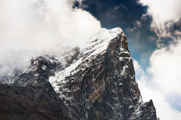 Naklejka na ściany i meble Peak of mount Taboche with clouds in Himalaya mountains. Khumbu valley, Everest region, Nepal