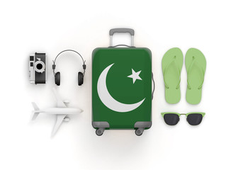 Pakistan flag suitcase and travel accessories lay flat. 3D Render
