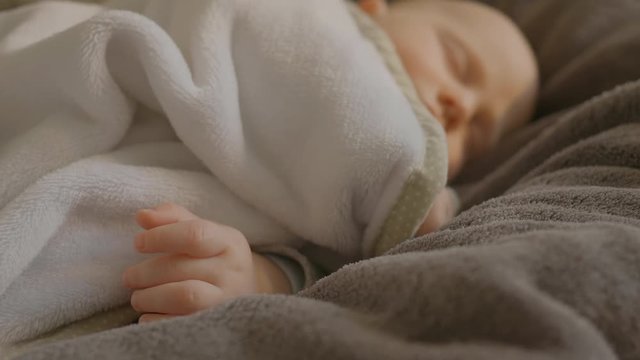 Baby sleeping, the camera focused on its hands